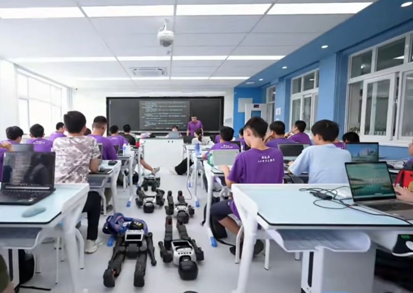 A trainer leads a robotics lesson in a classroom